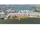 Wide aerial shot of the condo complex on the water, highlighting the pool and pier at 1847 Shore S Dr # 203, South Pasadena, FL 33707