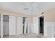 Bedroom shows a ceiling fan, closet, and doorway with unfinished flooring at 1847 Shore S Dr # 203, South Pasadena, FL 33707