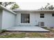The back exterior of the house, showing the sliding glass door and patio at 18838 Rosephil St, Spring Hill, FL 34610