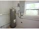An unfinished basement area showing the hot water heater and utility box at 18838 Rosephil St, Spring Hill, FL 34610