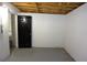 Unfinished basement with concrete floor, white walls, and a black door at 18838 Rosephil St, Spring Hill, FL 34610