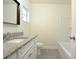 Well-maintained bathroom featuring granite countertop, and a shower-tub combo at 18838 Rosephil St, Spring Hill, FL 34610