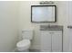 Clean bathroom featuring tile floors, new vanity, and modern lighting fixtures at 18838 Rosephil St, Spring Hill, FL 34610