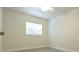 Bedroom featuring light walls, modern flooring, and a window for natural light at 18838 Rosephil St, Spring Hill, FL 34610
