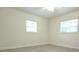 Clean and bright bedroom featuring neutral walls and modern flooring with two windows at 18838 Rosephil St, Spring Hill, FL 34610
