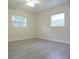 Bedroom featuring hard surface floors, two windows, and neutral paint at 18838 Rosephil St, Spring Hill, FL 34610