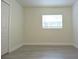 Bedroom featuring light walls, modern flooring, a window, and a closet at 18838 Rosephil St, Spring Hill, FL 34610