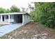 Side view of a well-kept single-story home showing the driveway and greenery at 18838 Rosephil St, Spring Hill, FL 34610