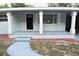 Inviting front porch with classic columns and walkway leading to the front door at 18838 Rosephil St, Spring Hill, FL 34610