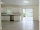 Modern kitchen featuring stainless steel appliances, granite counters, and sliding door access to the backyard at 18838 Rosephil St, Spring Hill, FL 34610