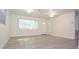 Bright living room with new floors, ceiling fans, and a large window for natural light at 18838 Rosephil St, Spring Hill, FL 34610