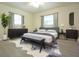 Well-lit main bedroom with hard surface floors, two windows, and modern decor at 18838 Rosephil St, Spring Hill, FL 34610
