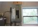 Utility room showing a gray electric panel, water heater and a window at 18838 Rosephil St, Spring Hill, FL 34610
