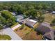 Bird's-eye view of a home with a screened-in pool and backyard, nestled in a tree-lined community at 2192 Meredith Dr, Spring Hill, FL 34608
