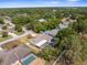 Beautiful aerial of home with screened in pool in a neighborhood surrounded by mature trees at 2192 Meredith Dr, Spring Hill, FL 34608