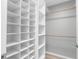 Well-organized walk-in closet with custom shelving and hanging rods, offering ample storage at 2192 Meredith Dr, Spring Hill, FL 34608