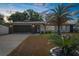 Charming one-story home with a well-manicured lawn and a spacious driveway at sunset at 2192 Meredith Dr, Spring Hill, FL 34608