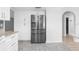 Open kitchen view with stainless steel refrigerator and granite countertop island at 2192 Meredith Dr, Spring Hill, FL 34608