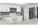 Well-lit kitchen with granite counters, stainless steel microwave, and white appliances at 2192 Meredith Dr, Spring Hill, FL 34608