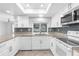 Updated kitchen features granite countertops, white cabinetry, and modern appliances at 2192 Meredith Dr, Spring Hill, FL 34608