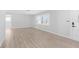 Bright living room featuring shuttered windows and hardwood floors at 2192 Meredith Dr, Spring Hill, FL 34608