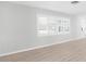 Bright living room featuring shuttered windows and hardwood floors at 2192 Meredith Dr, Spring Hill, FL 34608
