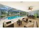 Inviting screened-in pool area perfect for outdoor living with comfortable seating and dining space at 2192 Meredith Dr, Spring Hill, FL 34608