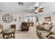 Spacious living room features neutral carpet, ceiling fan, and a view of the dining area and bar seating at 2292 Wyndam Dr, Spring Hill, FL 34606