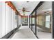 Long sunroom featuring sliding glass doors, carpet flooring, ceiling fans, and bright natural light at 2292 Wyndam Dr, Spring Hill, FL 34606