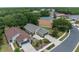 Aerial view of home showcasing a lush landscaping, driveway, and mature trees at 261 Rochester St, Spring Hill, FL 34609