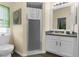 Neat bathroom featuring a glass enclosed shower, a sink, and a window for natural light at 261 Rochester St, Spring Hill, FL 34609