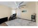 Inviting bedroom featuring a large ceiling fan, a massage chair, and neutral decor at 261 Rochester St, Spring Hill, FL 34609