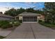 Charming home featuring a well-kept lawn, two-car garage, and welcoming curb appeal at 261 Rochester St, Spring Hill, FL 34609