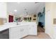 Modern eat-in kitchen featuring white cabinets, tile floors, and an open concept design at 261 Rochester St, Spring Hill, FL 34609