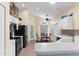 Bright eat-in kitchen featuring white cabinetry, modern appliances, and ample counter space at 261 Rochester St, Spring Hill, FL 34609
