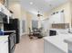 Bright kitchen features white cabinets, tile backsplash, stainless appliances, and a cozy dining area at 261 Rochester St, Spring Hill, FL 34609