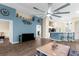 Spacious living room featuring hard flooring, a large ceiling fan, and open floor plan at 261 Rochester St, Spring Hill, FL 34609