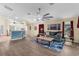 Well-lit open concept living room showcasing hard floors, ceiling fan, and modern decor at 261 Rochester St, Spring Hill, FL 34609