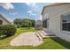 Well-maintained backyard features a brick paver patio, manicured lawn, and access to the sunroom at 284 Quane Ave, Spring Hill, FL 34609