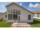 Backyard features a brick paver patio, lush lawn and view of the sunroom, creating a serene outdoor setting at 284 Quane Ave, Spring Hill, FL 34609