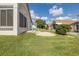 Well-kept backyard features a brick paver patio and lush lawn with an enclosed porch at 284 Quane Ave, Spring Hill, FL 34609