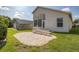 Backyard features a brick paver patio and steps up to the sunroom, surrounded by a well-maintained lawn at 284 Quane Ave, Spring Hill, FL 34609