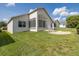 Spacious backyard with brick paver patio, lush lawn, and views of neighboring homes and landscaping at 284 Quane Ave, Spring Hill, FL 34609