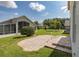 Well-maintained backyard features a brick paver patio, manicured lawn and lush landscaping providing a relaxing outdoor space at 284 Quane Ave, Spring Hill, FL 34609