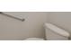 Bathroom featuring accessibility grab bars, toilet, and clean white walls at 284 Quane Ave, Spring Hill, FL 34609
