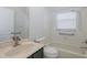 Bathroom with grab bars, tiled shower, and vanity with faucet under a window at 284 Quane Ave, Spring Hill, FL 34609