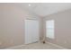 Bedroom with neutral walls, tile flooring, window, and double-door closet at 284 Quane Ave, Spring Hill, FL 34609
