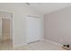 Bedroom with tile floor, neutral paint, double closet doors and view to hallway at 284 Quane Ave, Spring Hill, FL 34609