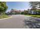 Elegant clubhouse exterior with covered entrance, landscaped grounds, and ample parking at 284 Quane Ave, Spring Hill, FL 34609