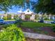 Attractive clubhouse entrance featuring well-manicured landscaping and ample parking at 284 Quane Ave, Spring Hill, FL 34609